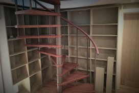 Photo of MDF Bookcase behind spiral stairs