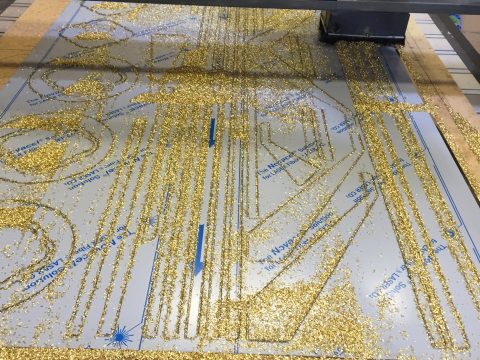 Photo of 2mm brass components being cut on our CNC router
