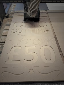 Photo of sign being cut by CNC router
